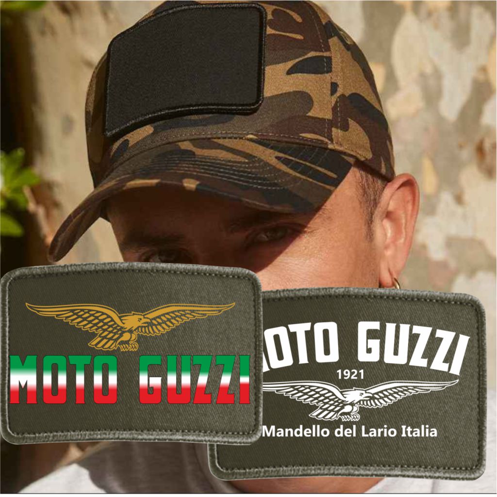 Person wearing a camouflage cap with Moto Guzzi patches displayed in front.