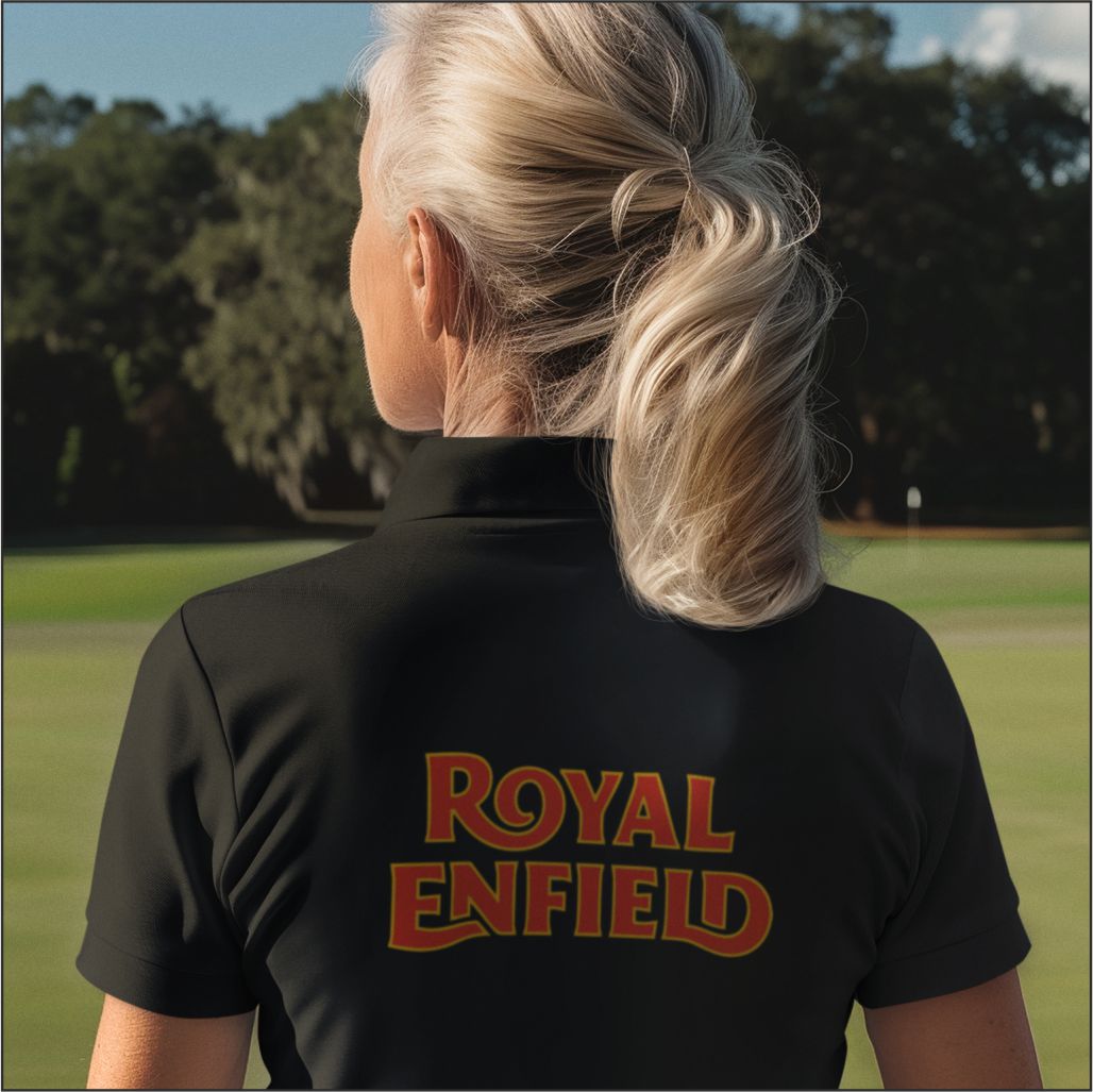 Person wearing a black shirt with 'Royal Enfield' logo on the back, standing outdoors.