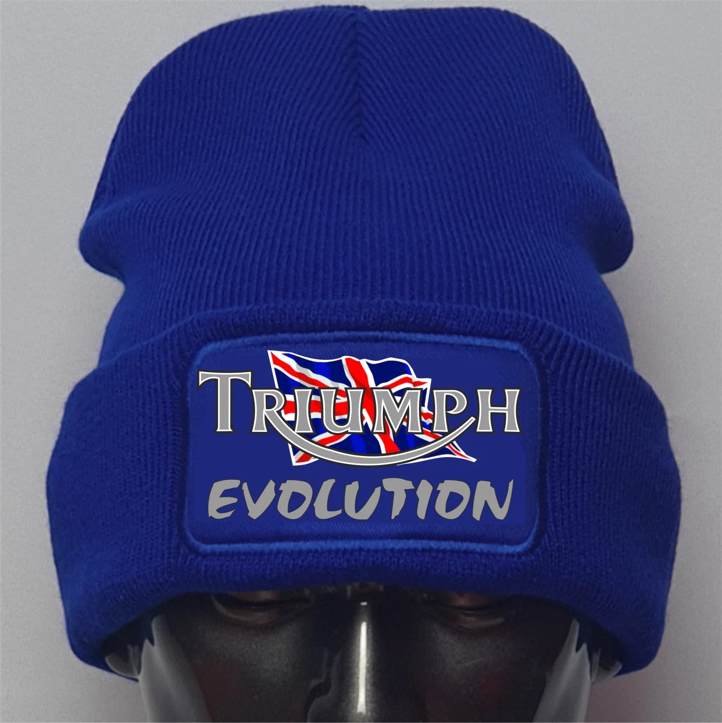 Blue beanie with Triumph Evolution logo on a gray background