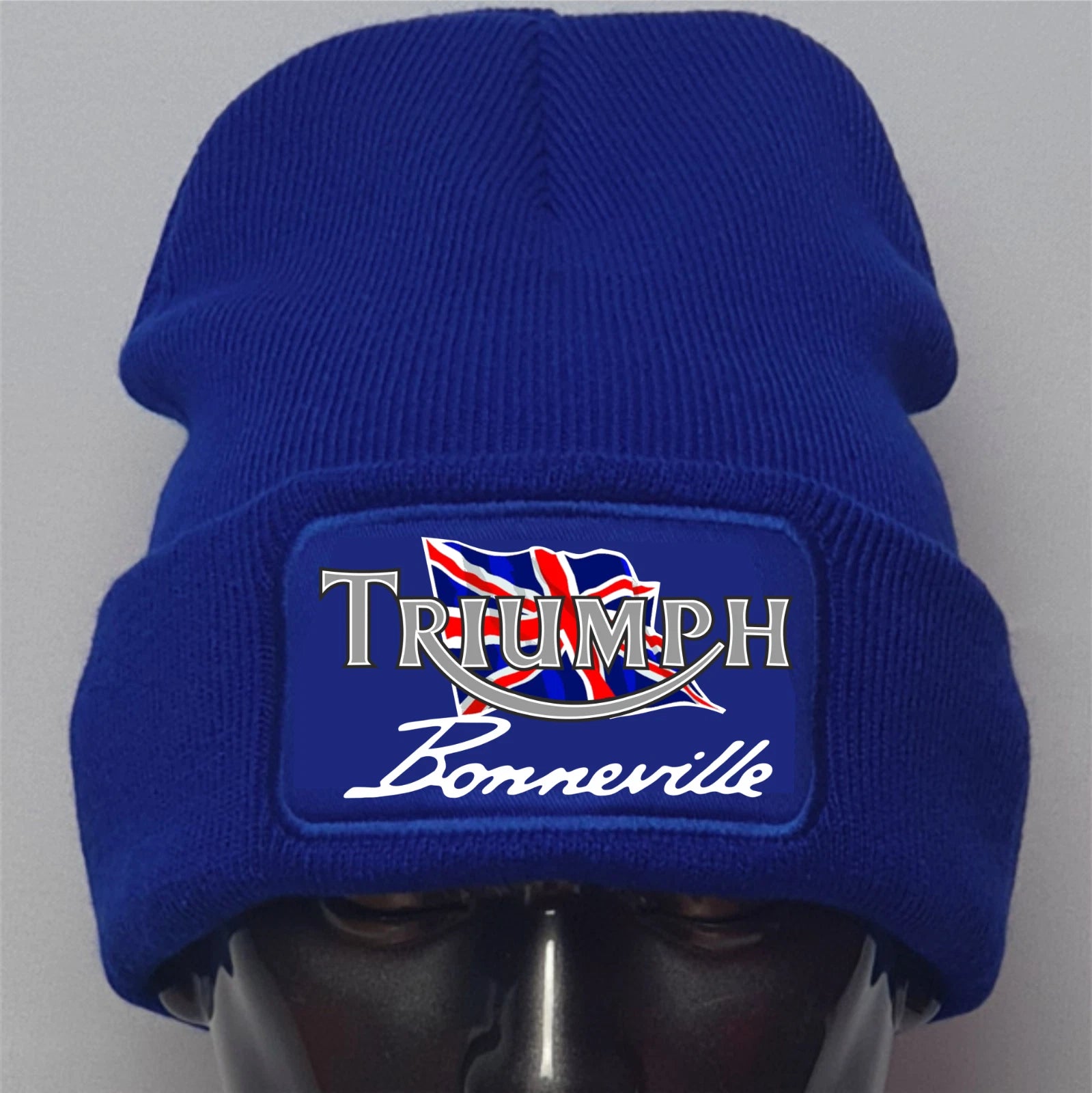 Blue beanie with Triumph Bonneville logo on a gray background