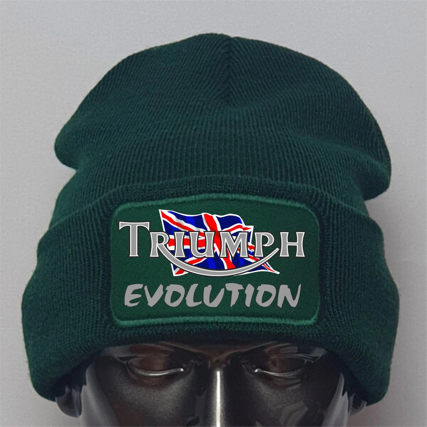 Green beanie with Triumph Evolution logo on a gray background
