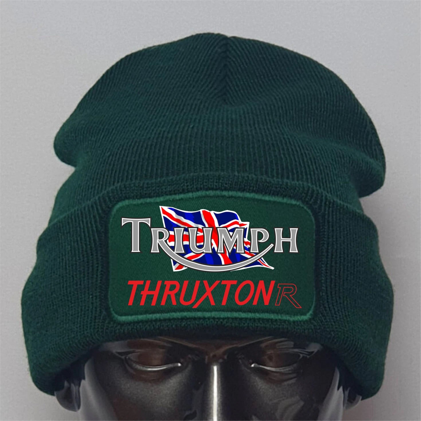 Green beanie with Triumph Thruxton logo on a gray background