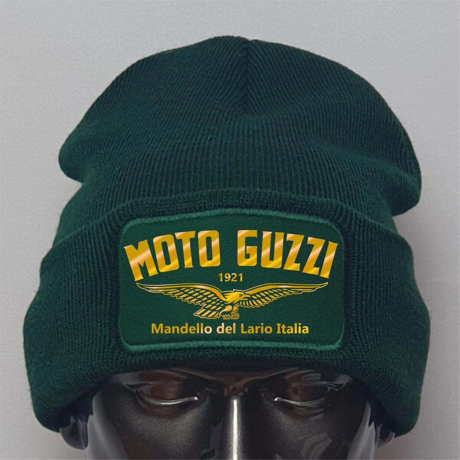 Green beanie with Moto Guzzi logo on a gray background