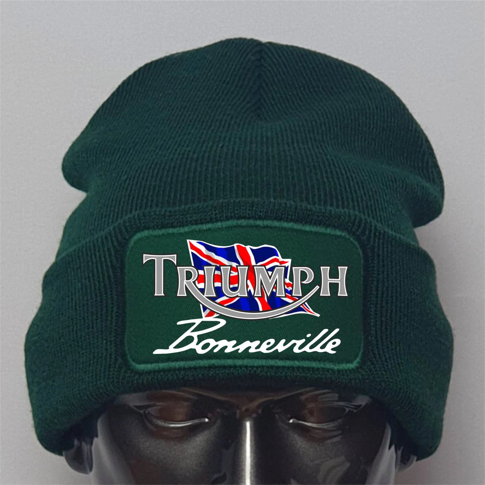 Green beanie with Triumph Bonneville logo on a mannequin head against a gray background