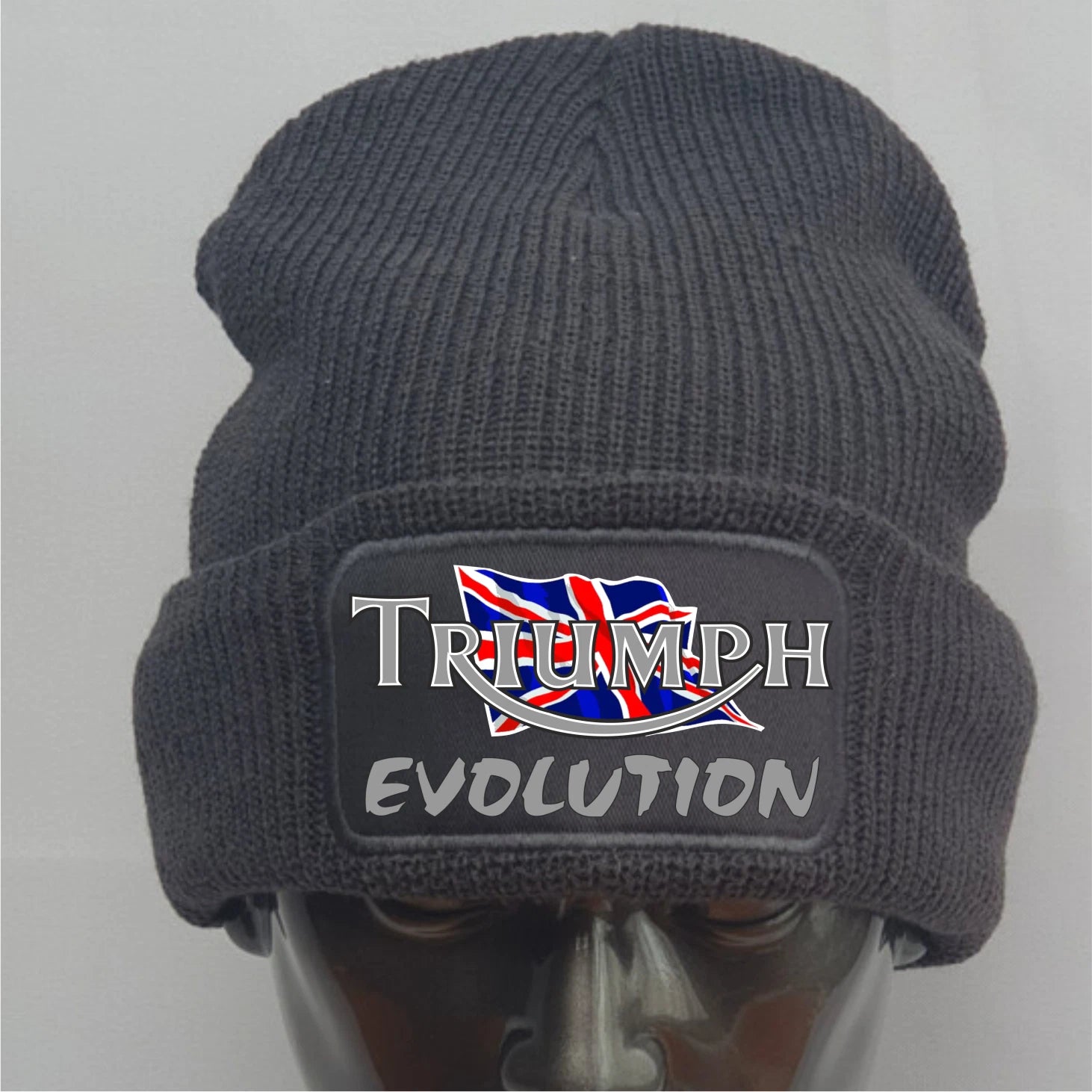 Gray knit beanie with Triumph Evolution logo on a mannequin head against a gray background