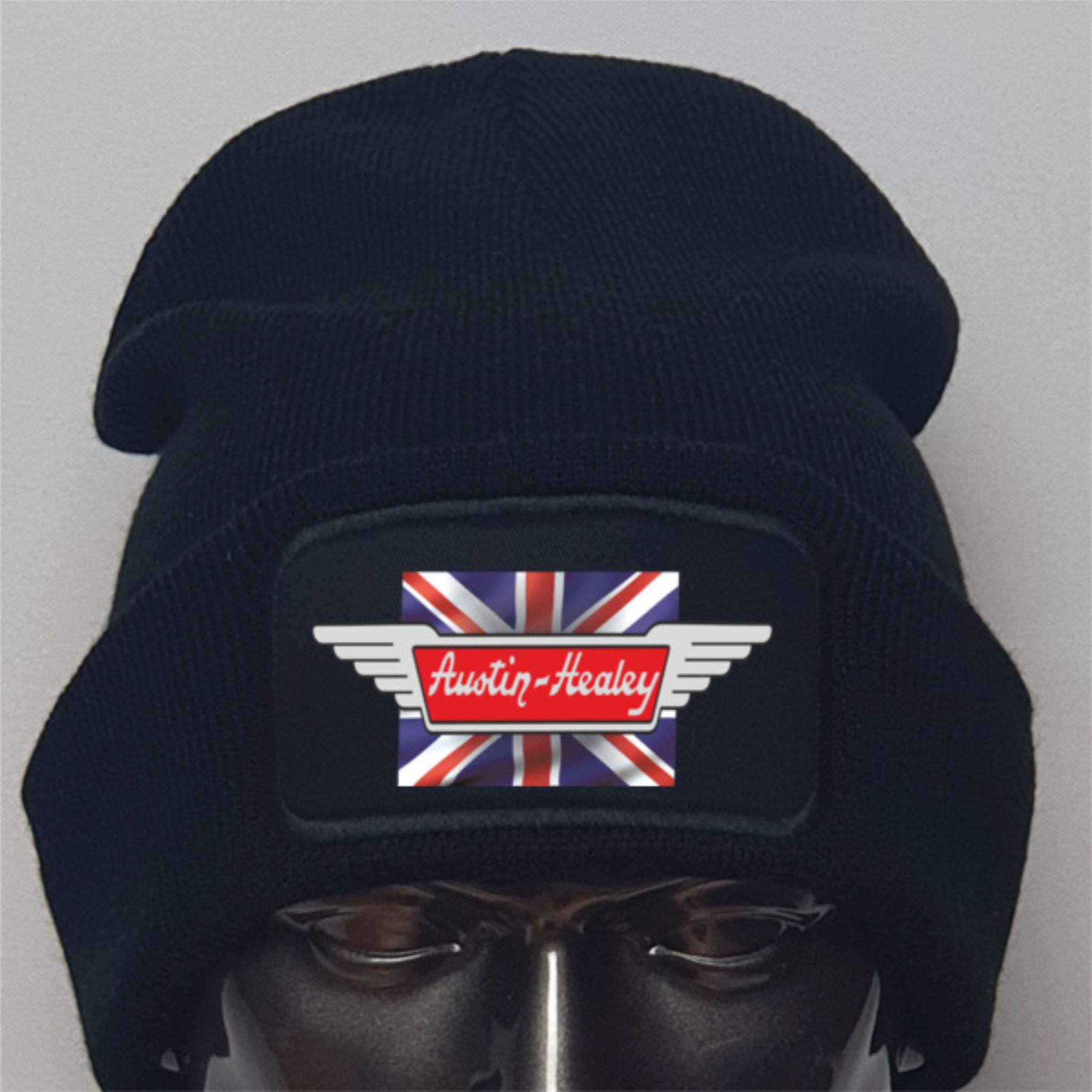 Black beanie with Austin-Healey logo featuring a British flag on a gray background