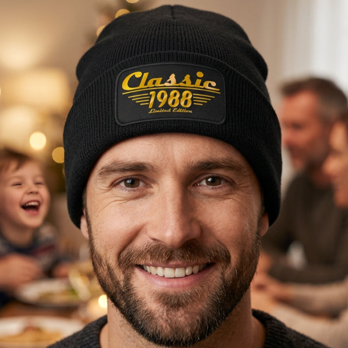 A customizable black ribbed knit beanie hat featuring a rectangular embroidered patch on the front cuff with the text 'Classic Your own YEAR Limited Edition' in gold.