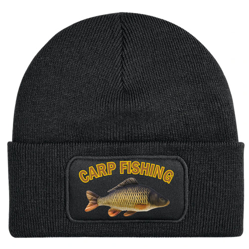 A black ribbed knit beanie hat featuring a rectangular printed patch on the front cuff with the words 'CARP FISHING' in yellow and an illustration of a carp fish.