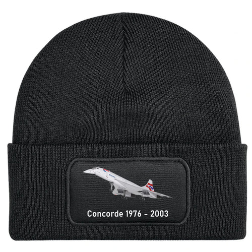 A black ribbed knit beanie hat featuring a rectangular embroidered patch on the front cuff. The patch shows a white Concorde supersonic jet with its red and blue tail stripes, and the text 'Concorde 1976 - 2003' in white below it.