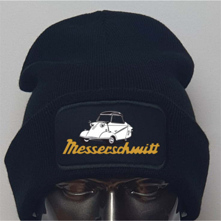 Black beanie with embroidered design and 'Messerschmitt' text on a gray background