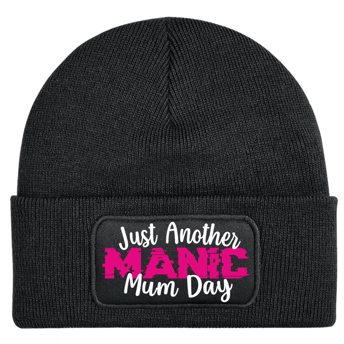 A black ribbed knit beanie hat with a folded cuff, featuring a rectangular printed patch on the front that reads 'Just Another MANIC Mum Day' in white and bright pink lettering.