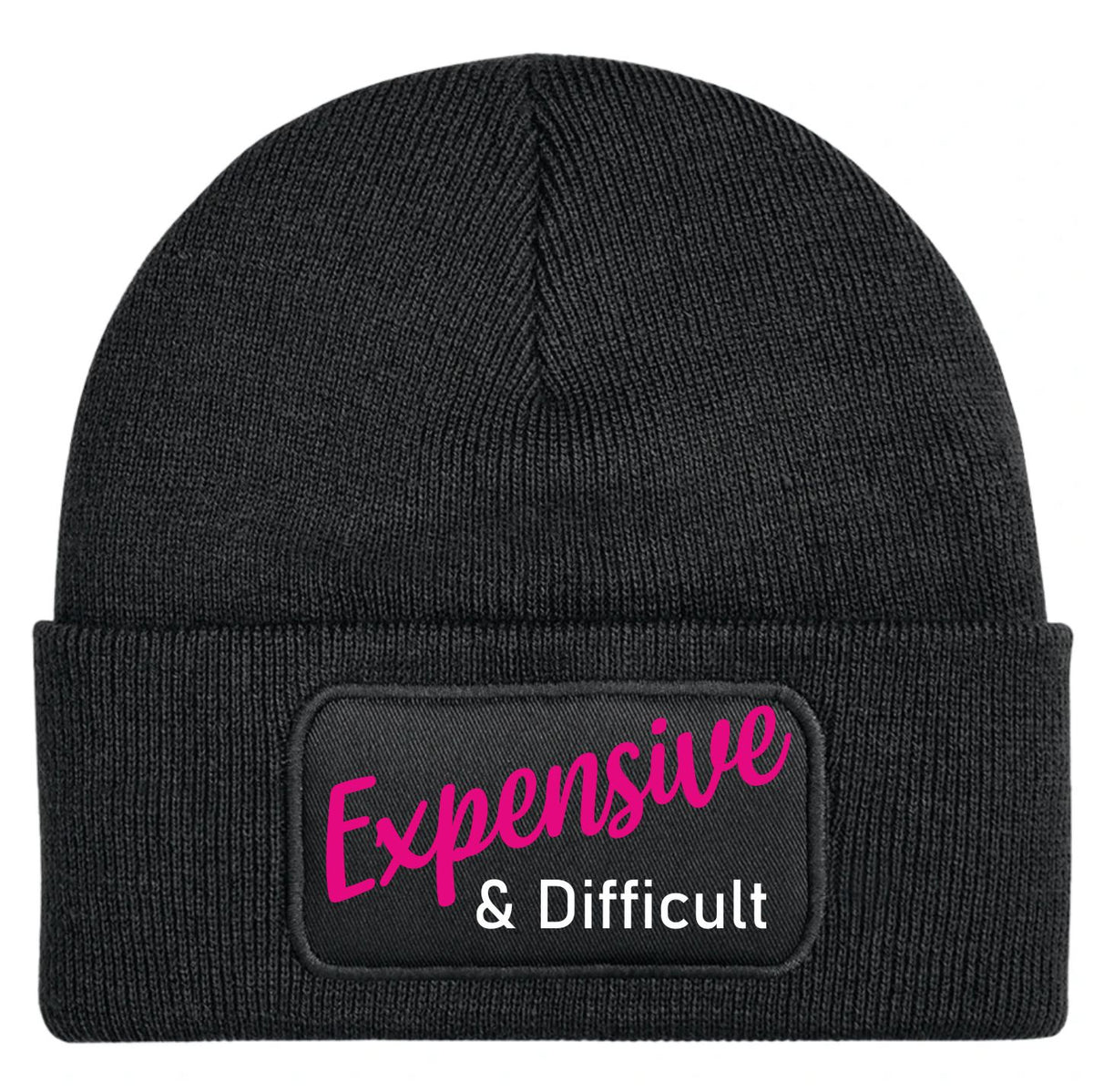 A black ribbed knit beanie hat featuring a rectangular black patch on the front cuff with the words 'Expensive & Difficult' in pink and white lettering, shown against a plain white background.