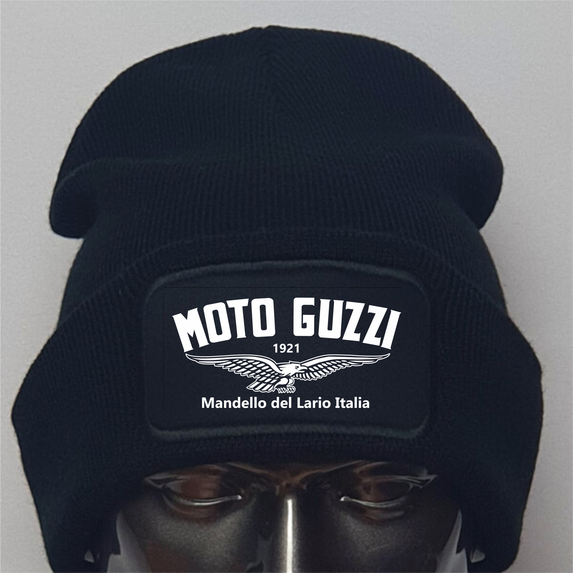 Black beanie with Moto Guzzi logo on a mannequin head against a gray background