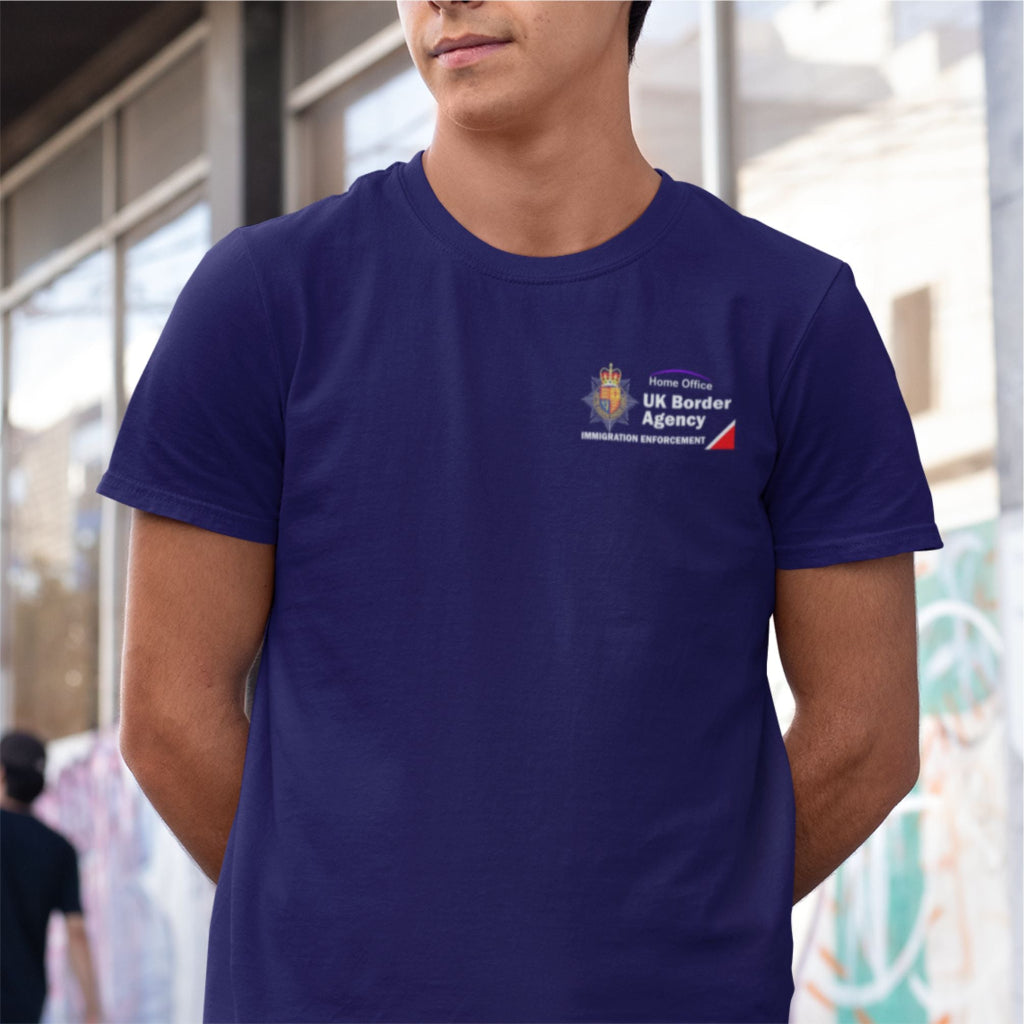 Person wearing a navy blue t-shirt with UK Border Agency logo.