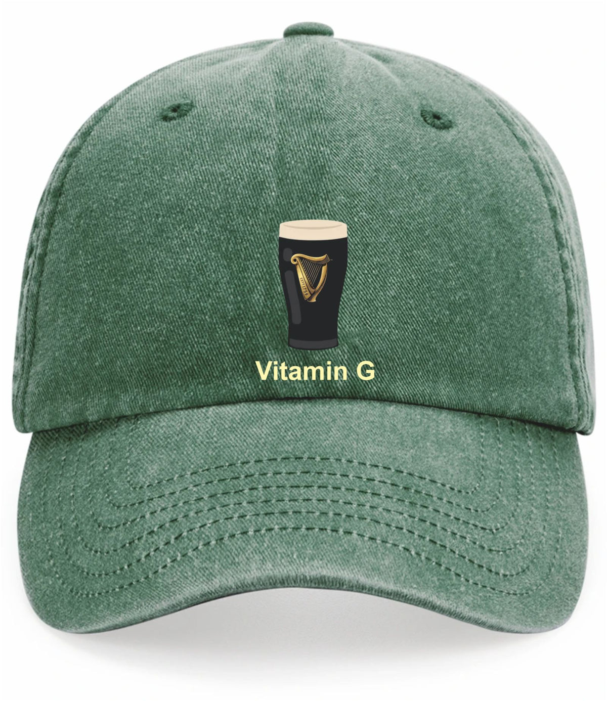 A green washed cotton baseball cap featuring an embroidered graphic of a black pint glass with a gold harp and the text 'Vitamin G' in yellow-green below it, shown against a plain white background.