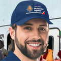 Person wearing a blue cap with UK Border Agency logo