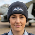 A dark gray ribbed knit beanie hat featuring a rectangular patch on the front cuff with the Royal Air Force wings emblem and 'RAF' text.