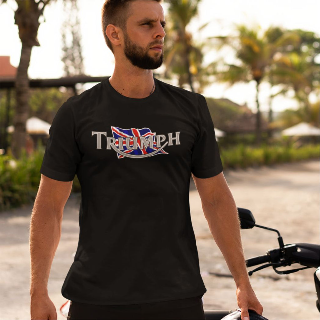 Man wearing a black Triumph t-shirt with a British flag design outdoors.