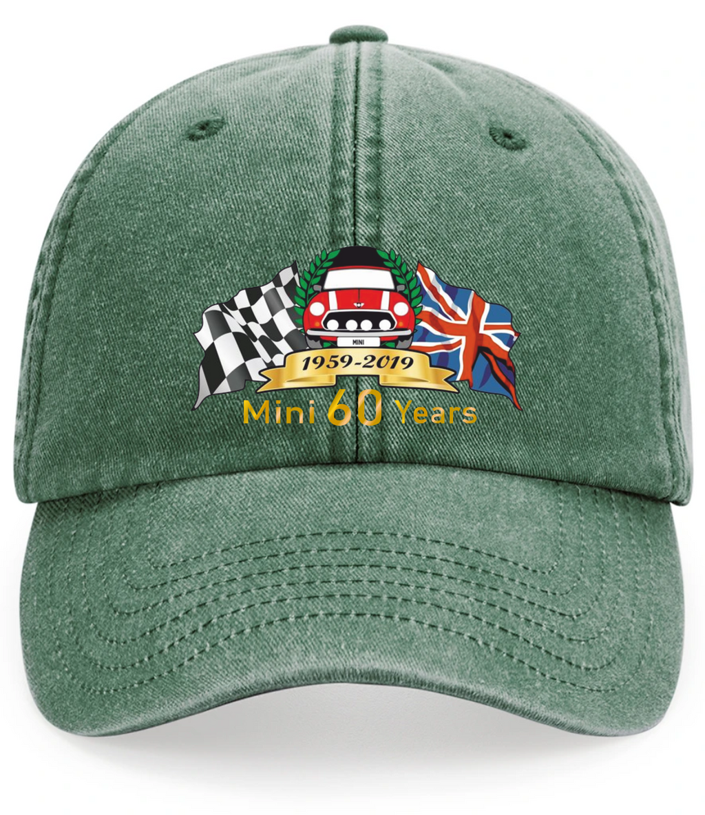 A green cotton baseball cap featuring a custom embroidered graphic on the front. The graphic includes a checkered flag, a red Mini Cooper car, the Union Jack, a gold banner reading '1959-2019', and the text 'Mini 60 Years'.