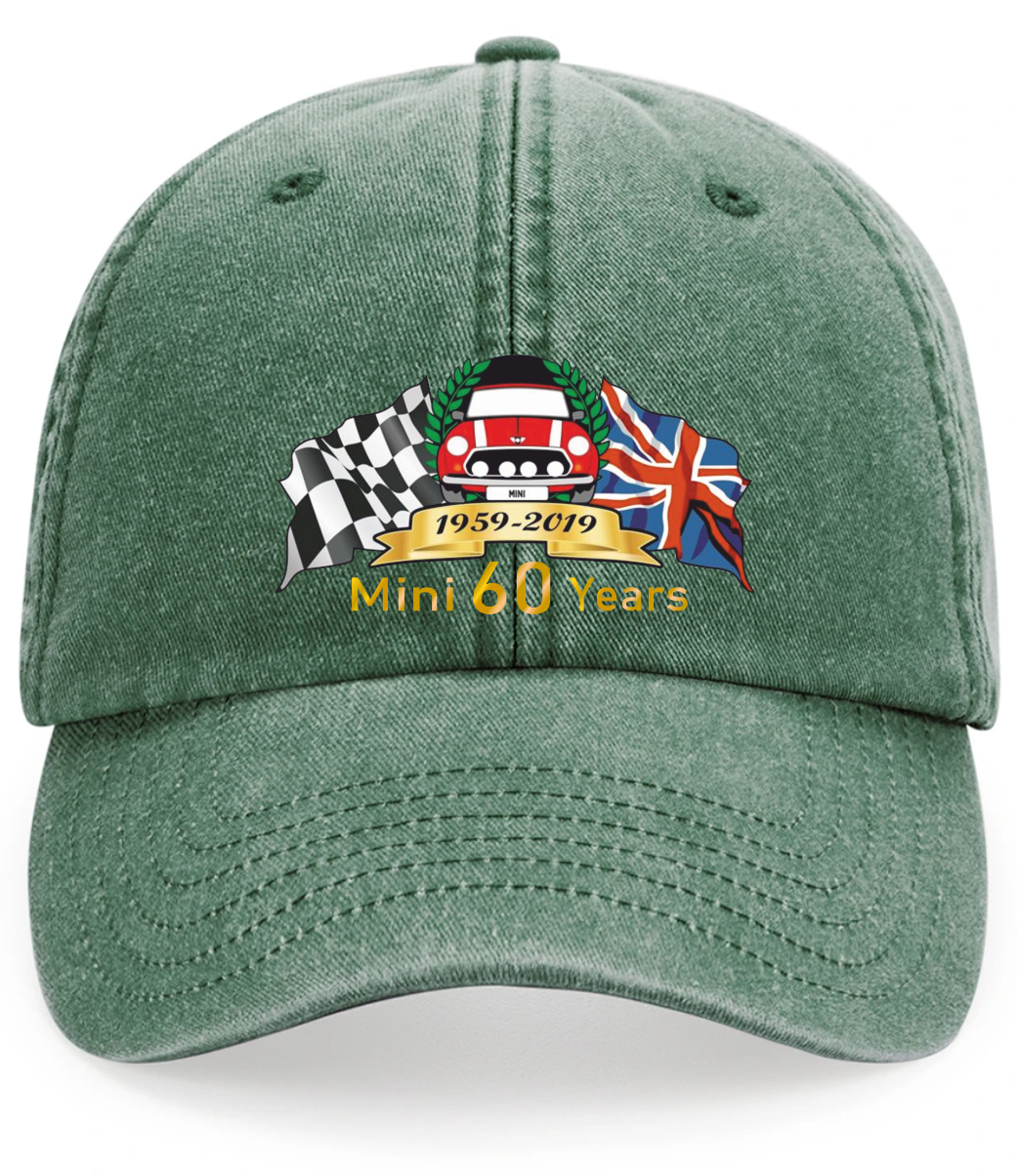 A green cotton baseball cap featuring a custom embroidered graphic on the front. The graphic includes a checkered flag, a red Mini Cooper car, the Union Jack, a gold banner reading '1959-2019', and the text 'Mini 60 Years'.