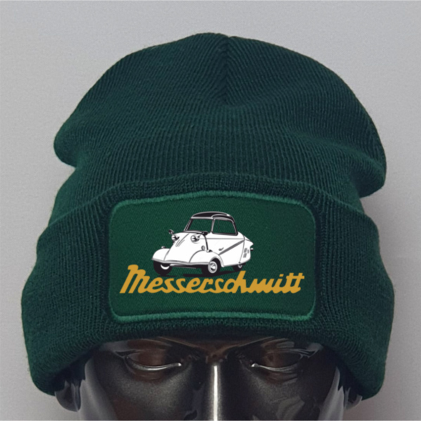 Green beanie with a patch featuring a car illustration and 'Messeschmitt' text on a gray background.