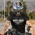Person wearing a Moto Guzzi t-shirt and helmet on a motorcycle.