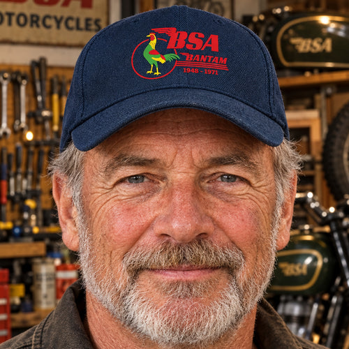A navy blue baseball cap featuring a red, green, and yellow embroidered logo on the front with the text 'BSA BANTAM 1945-1971'.