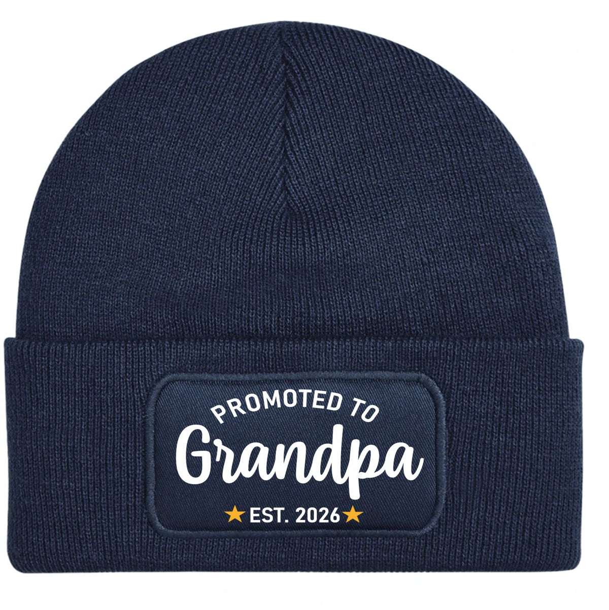 A navy blue ribbed knit beanie hat with a folded cuff featuring a rectangular printed patch that reads 'PROMOTED TO Grandpa EST. 2026' in white and yellow.