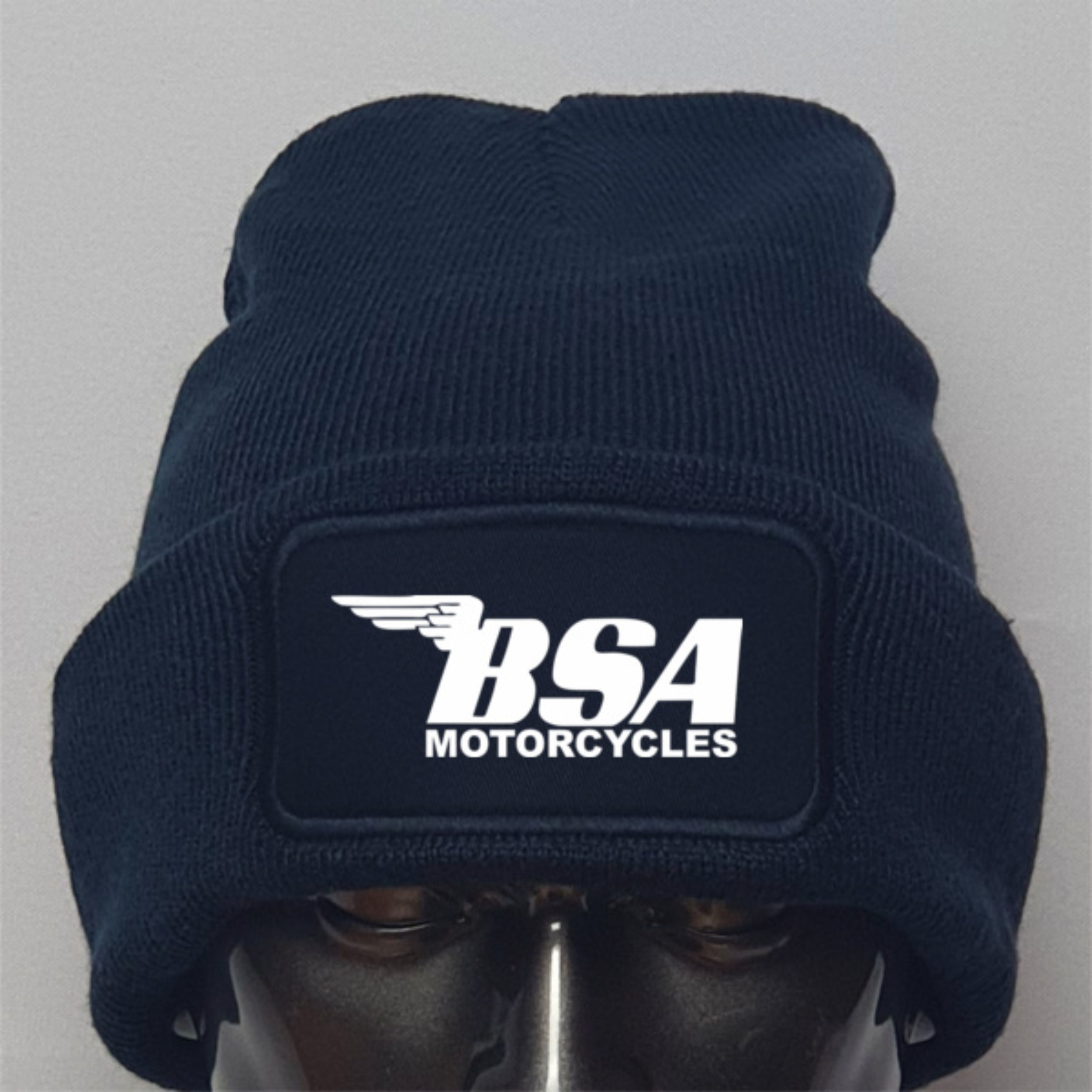 Navy blue beanie with BSA Motorcycles logo on a gray background