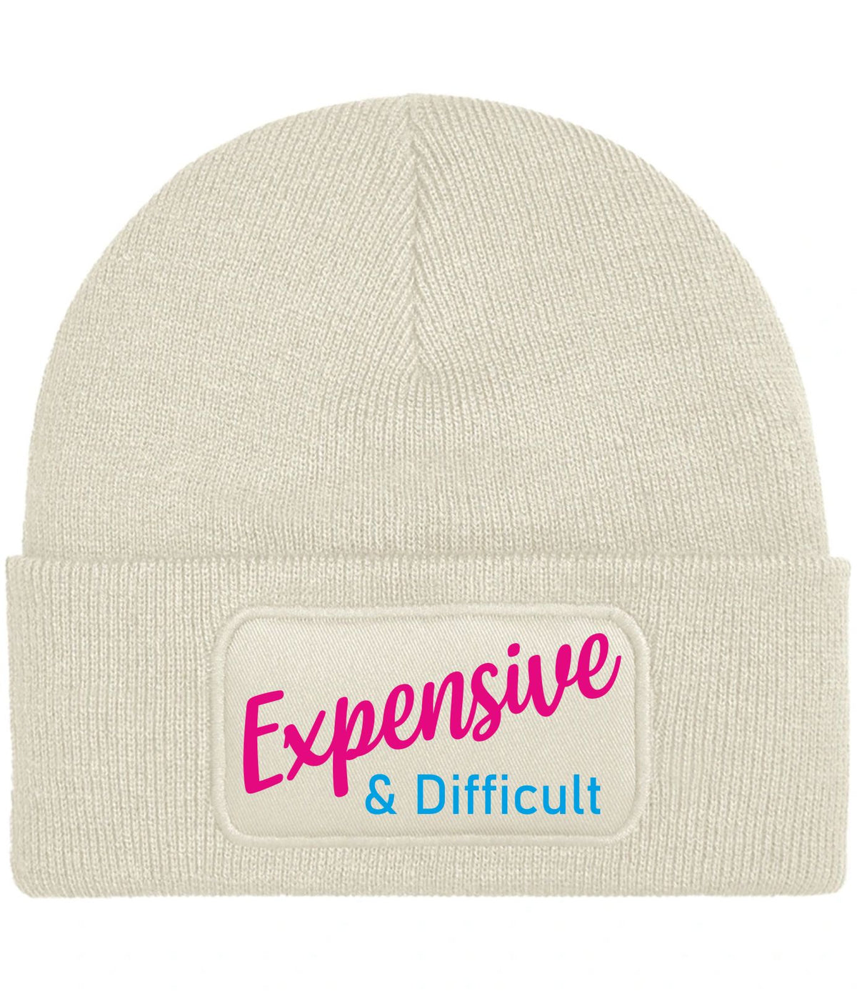 A cream-colored ribbed knit beanie hat featuring a rectangular printed patch on the front cuff with the text 'Expensive & Difficult' in pink and blue lettering.
