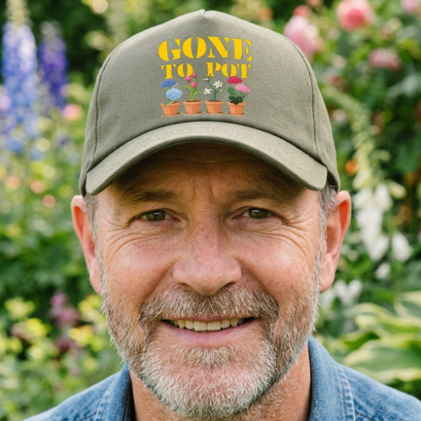 An olive green baseball cap with a curved brim, featuring a colorful graphic on the front that reads 'GONE TO POT' in yellow above four potted flowers in blue, pink, white, and purple.