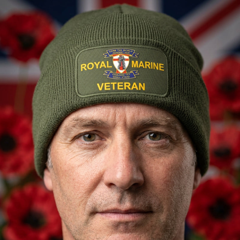 An olive green ribbed knit beanie with a folded cuff, featuring a rectangular Printed patch on the front that reads 'ROYAL MARINE VETERAN' with a Marine Corps emblem in the center.