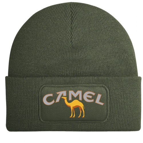 An olive green ribbed knit beanie hat featuring a rectangular printed patch on the front cuff with the cult classic 'CAMEL' logo in white outlined letters and a yellow camel illustration.
