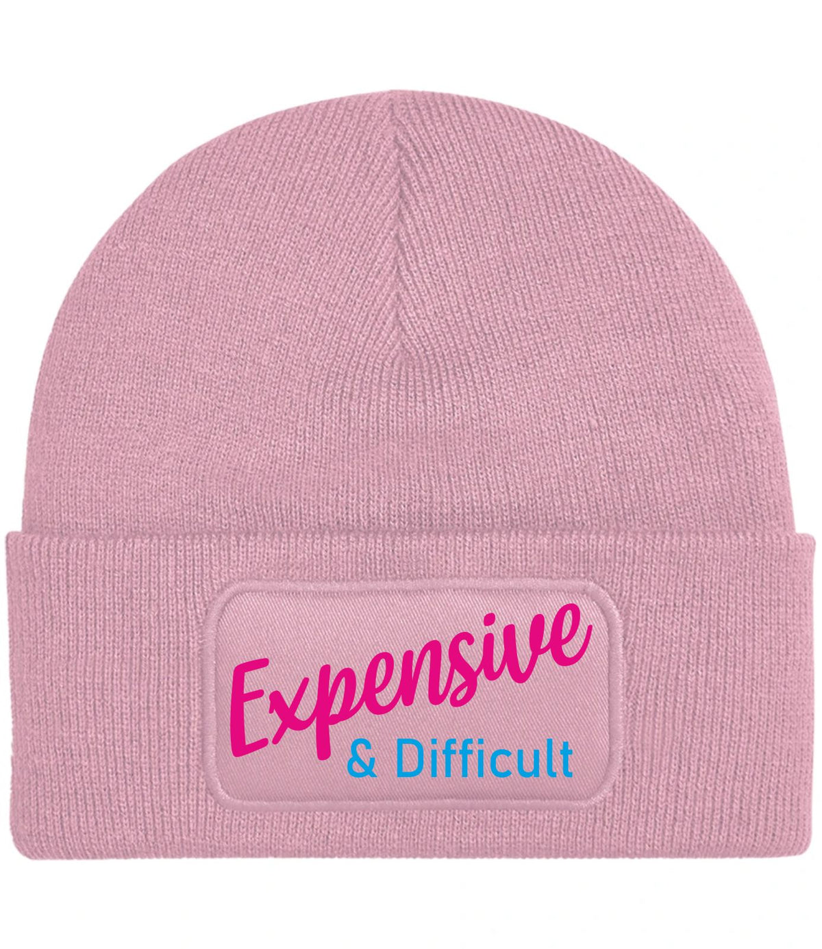A light pink ribbed knit beanie hat featuring a rectangular printed patch on the front cuff with the text 'Expensive & Difficult' in pink and blue lettering.