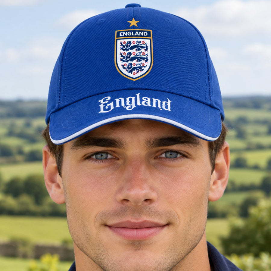 A royal blue baseball cap featuring the England national team crest printed on the front and 'England' written in white Gothic lettering across the brim.