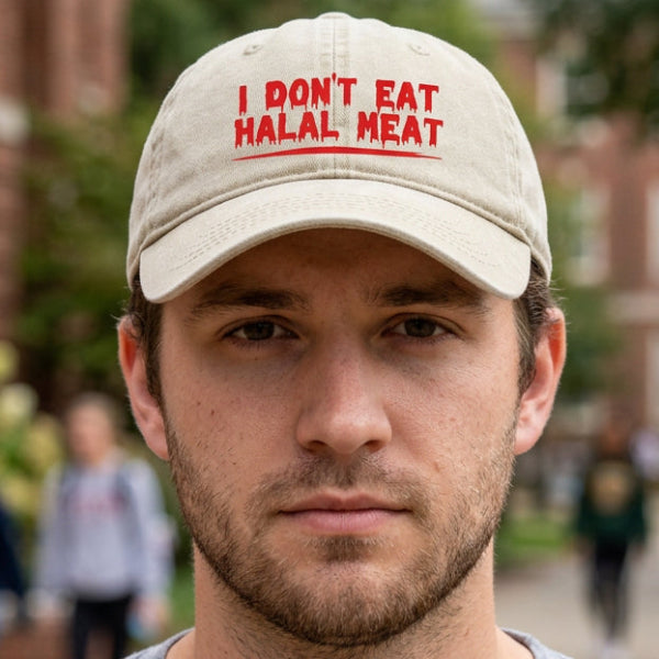 A beige cotton baseball cap with red printed text reading 'I DON'T EAT HALAL MEAT' on the front, shown against a plain white background.