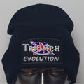 Black beanie with 'Triumph Evolution' logo on a mannequin head against a gray background