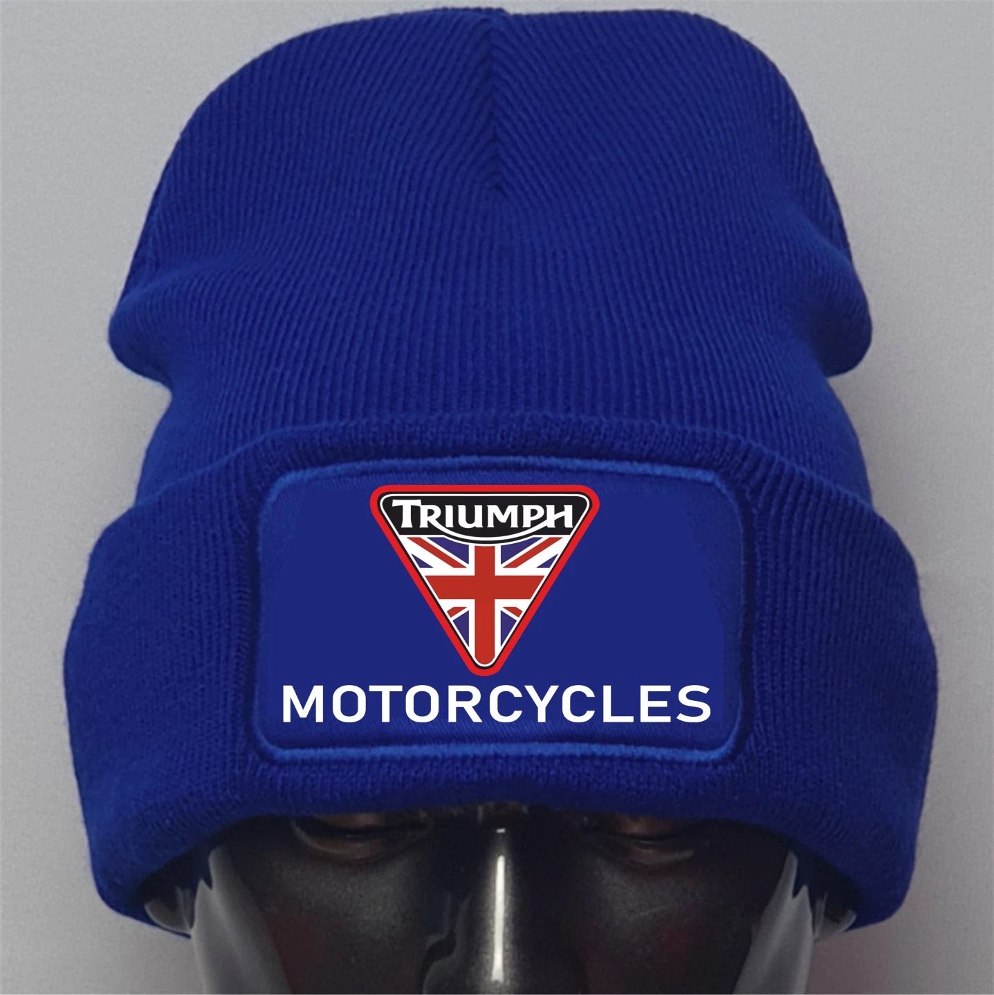 Blue beanie with Triumph Motorcycles logo on a gray background