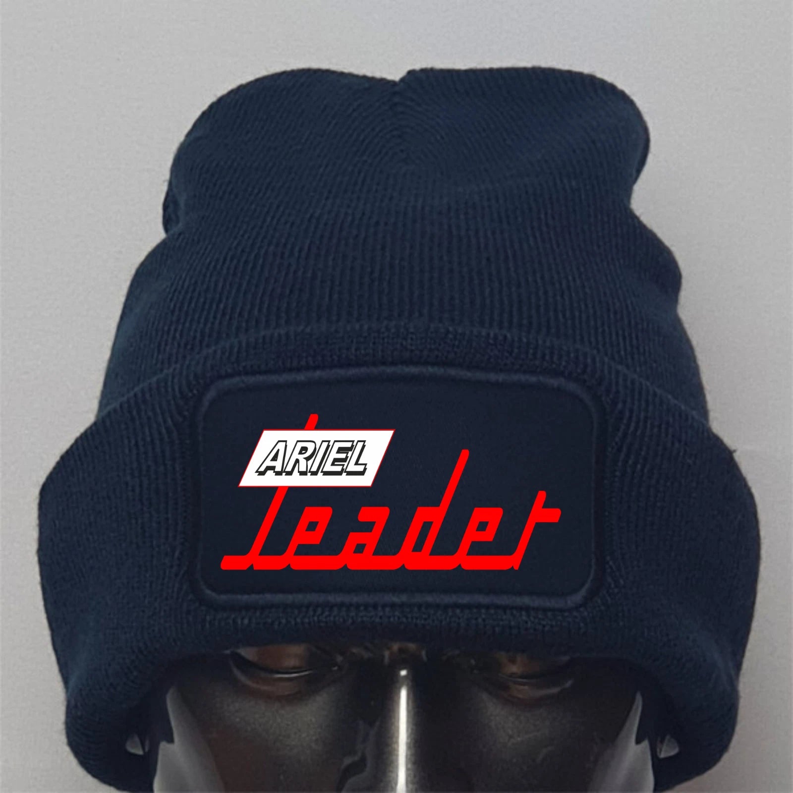 Navy blue beanie with 'Ariel Leader' logo on a gray background
