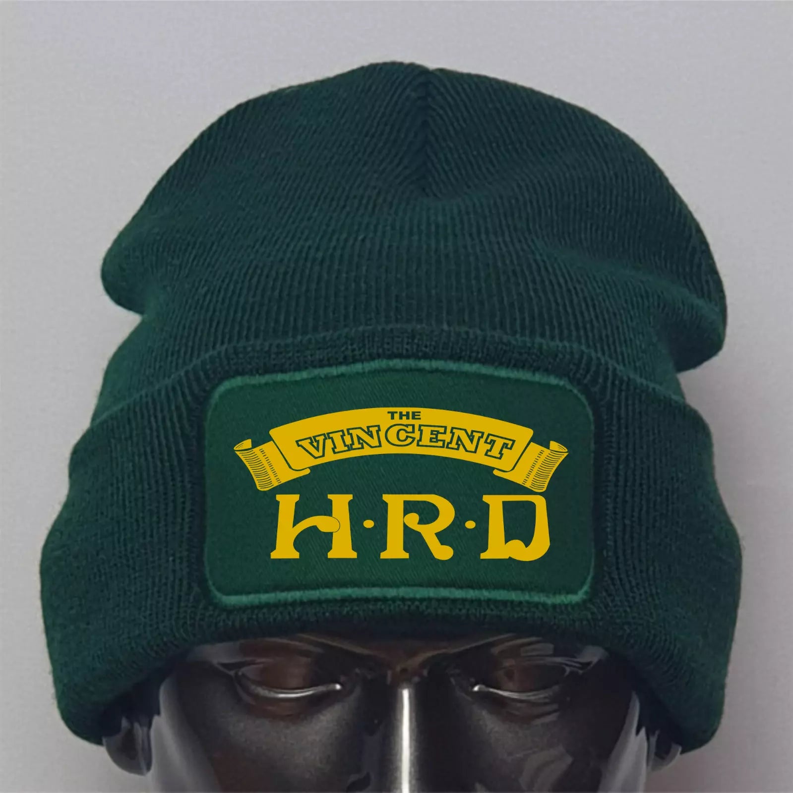 Green beanie with 'The Vincent H.R.D' logo on a gray background