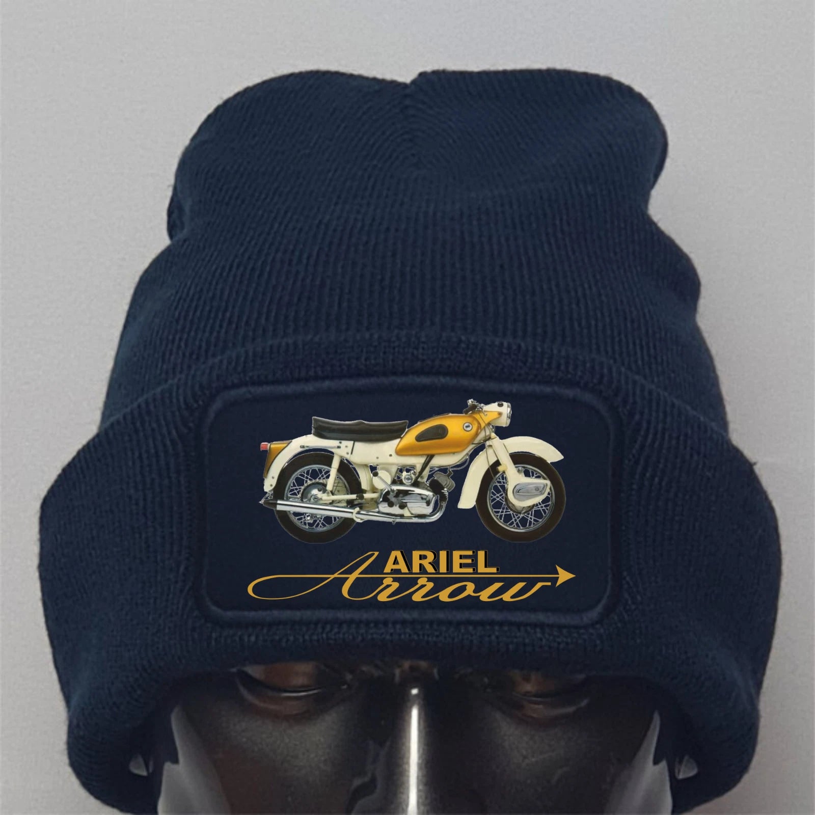 Navy blue beanie with 'Ariel Arrow' motorcycle design on a gray background