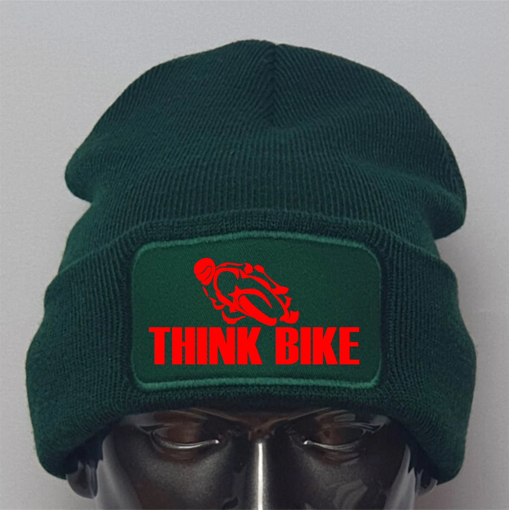 Green beanie with 'Think Bike' logo on a mannequin head against a gray background