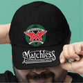 Black cap with Matchless logo held by a person against a teal background