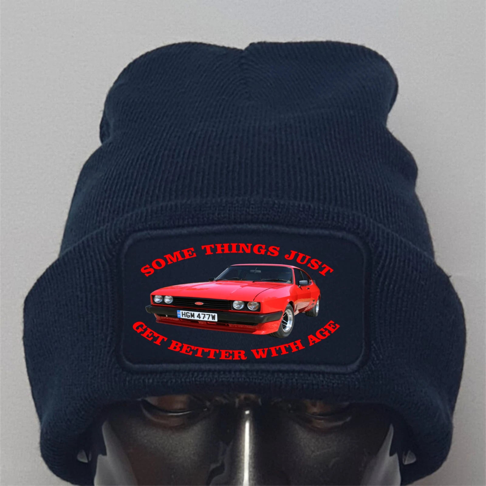 Navy blue beanie with a red car graphic and text on a gray background
