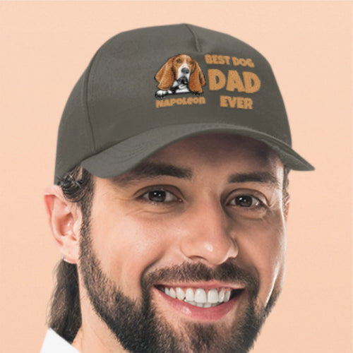 Man wearing a cap with 'Best Dog Dad Ever' text and dog illustration on a beige background