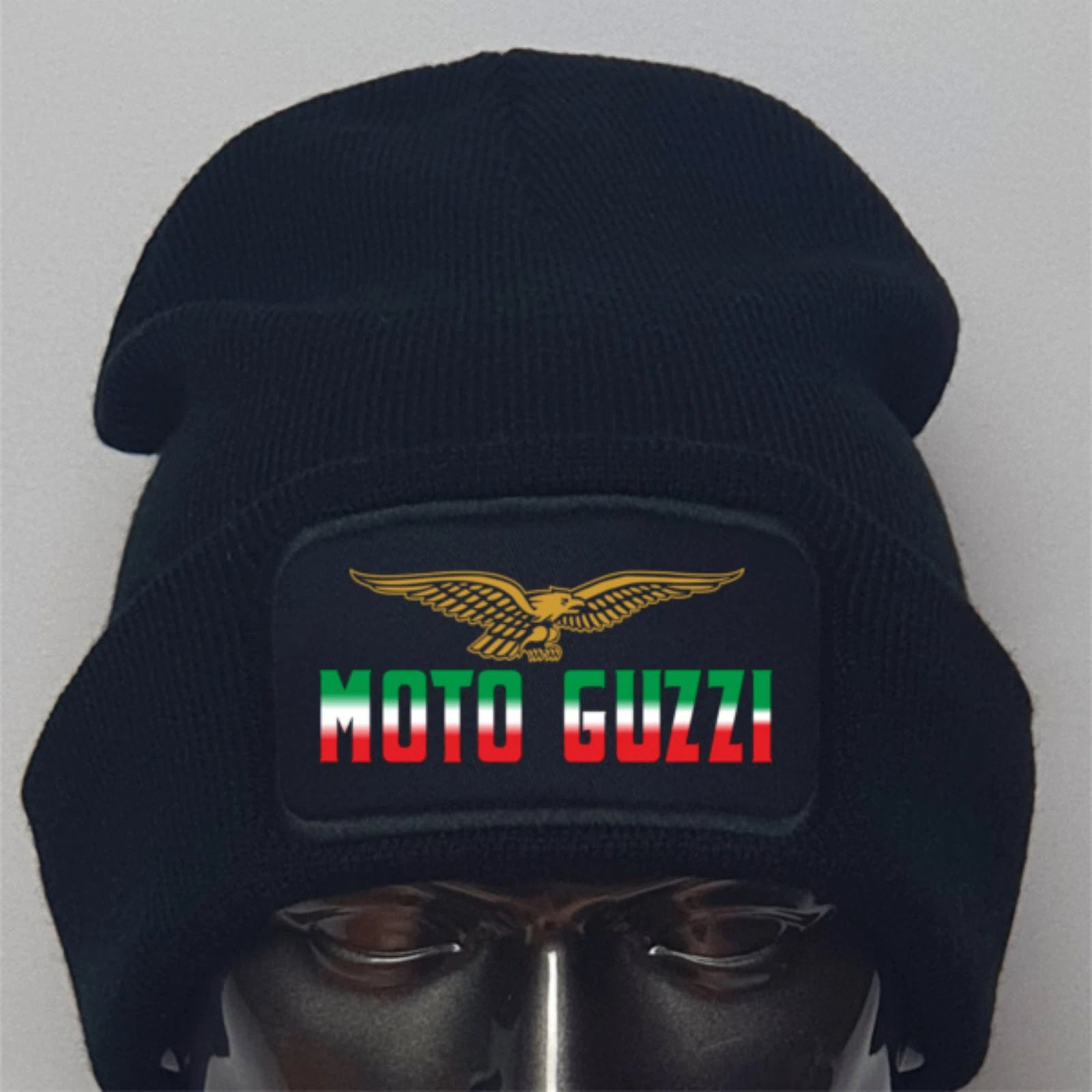 Black beanie with Moto Guzzi logo on a mannequin head against a gray background