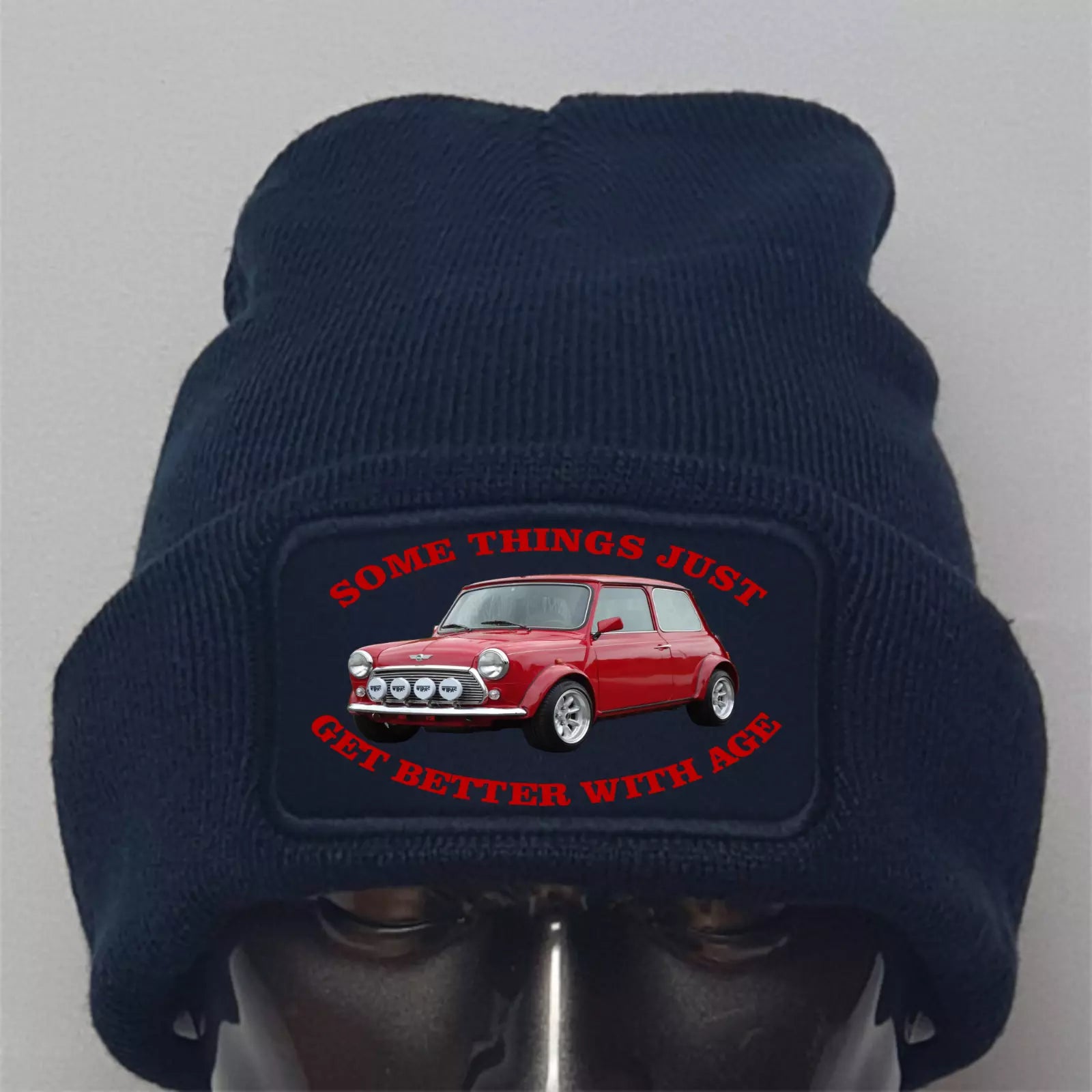 Navy blue beanie with a red car graphic and text on a gray background