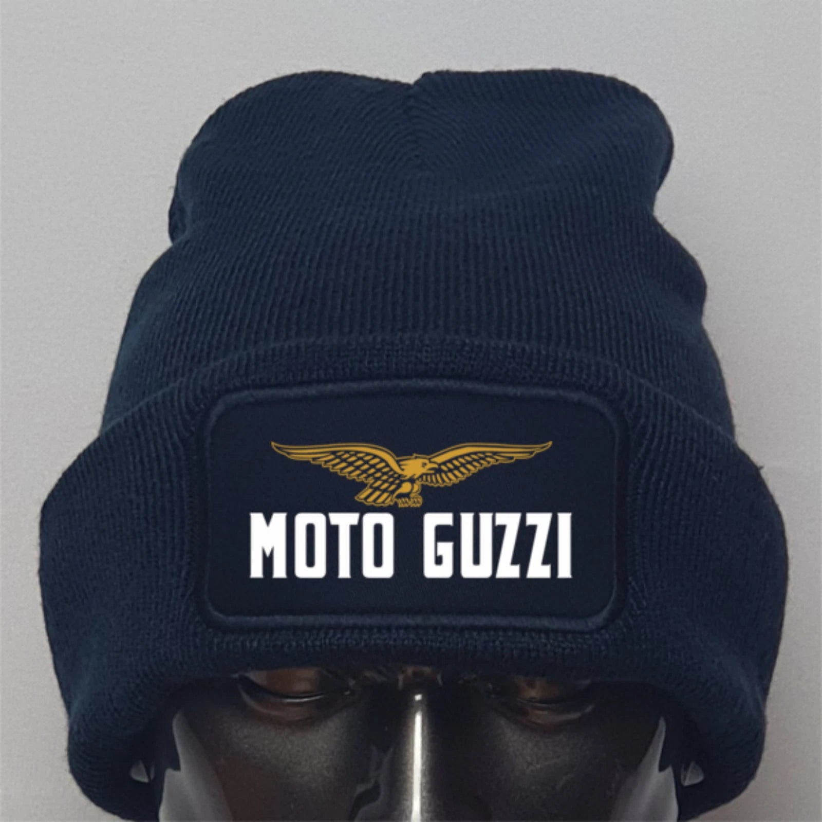 Navy blue beanie with Moto Guzzi logo on a gray background