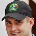 Person wearing a black cap with a St. Patrick's Day design, featuring the Irish flag.