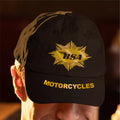 Black cap with yellow BSA Motorcycles logo worn by a person.